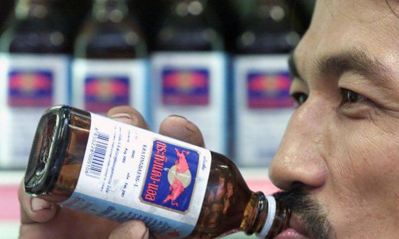 Một người đàn ông Thái Lan uống nước tăng lực Red Bull Một người đàn ông Thái Lan uống nước tăng lực Red Bull